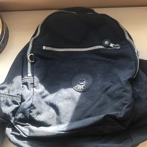 Gently used KIPLING medium backpack silver accent navy blue
